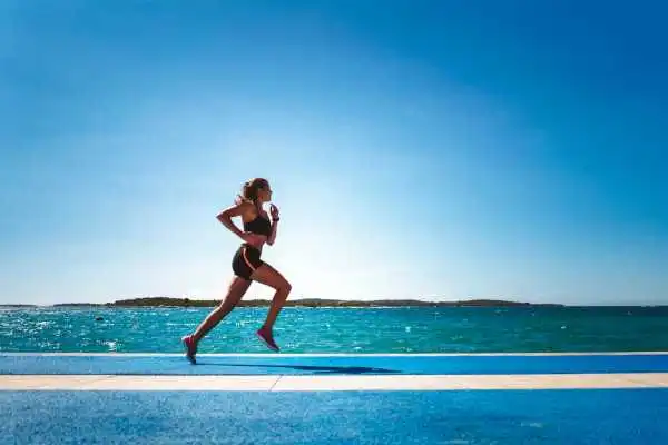 Woman running showing strong leg muscle Malvern Wells